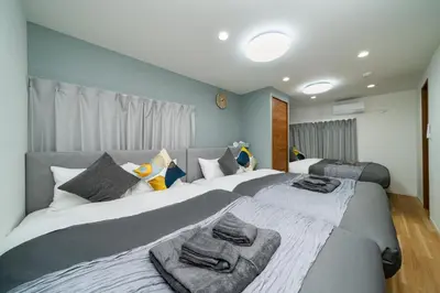 a bedroom with two beds with towels on them at 93, Yotsugi Seven, Entire house for rent, \u56db\u3064\u6728\u30bb\u30d6\u30f3 in Tokyo