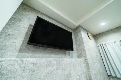 a flat screen tv on a wall in a room at 93, Yotsugi Seven, Entire house for rent, \u56db\u3064\u6728\u30bb\u30d6\u30f3 in Tokyo