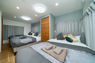 a bedroom with two beds with towels on them at 93, Yotsugi Seven, Entire house for rent, \u56db\u3064\u6728\u30bb\u30d6\u30f3 in Tokyo