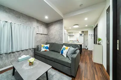 a living room with a couch and a table at 93, Yotsugi Seven, Entire house for rent, \u56db\u3064\u6728\u30bb\u30d6\u30f3 in Tokyo