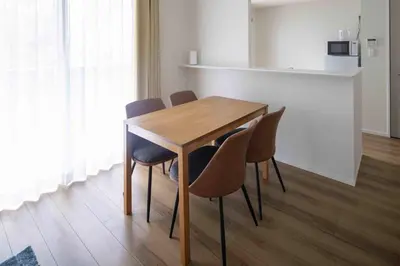 a dining room table with chairs around it at \u7be0\u30ac\u30fc\u30c7\u30f3\u30ec\u30b8\u30c7\u30f3\u30b9 in Tokyo