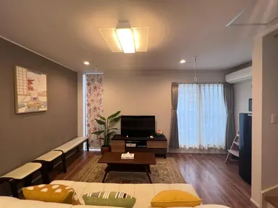 a living room with a couch and a tv at new open shinjuku house SJ0430 in Tokyo