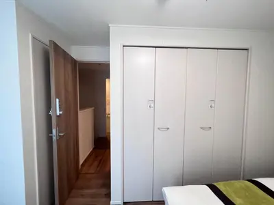 a bedroom with white wardrobes and a bed at new open shinjuku house SJ0430 in Tokyo
