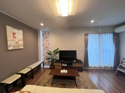 a living room with a couch and a tv at new open shinjuku house SJ0430 in Tokyo
