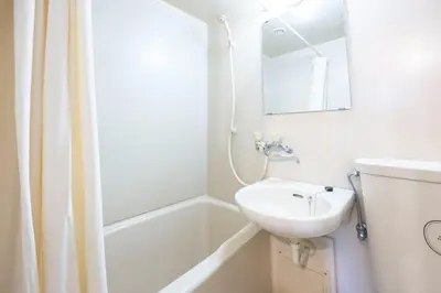 a white bathroom with a sink and a bath tub at \u9326\u7cf8\u753a\u30b9\u30ab\u30a4\u30a8\u30a4\u30c8 in Tokyo