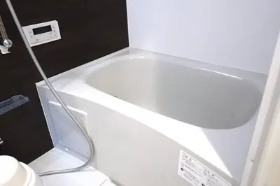a white bath tub in a bathroom with a toilet at Private Hotel Asakusa in Tokyo