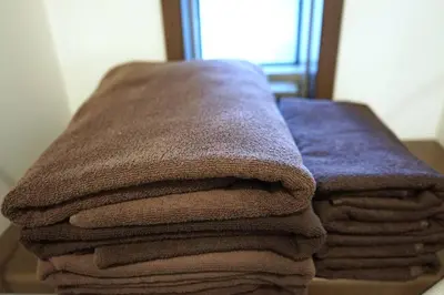 a pile of towels sitting on top of a table at Private Hotel Asakusa in Tokyo