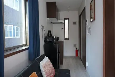 a living room with a couch and a window at Private Hotel Asakusa in Tokyo