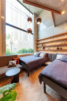 a bedroom with two beds and a couch at Premier suite New Shinjuku Kagurazaka front in Tokyo