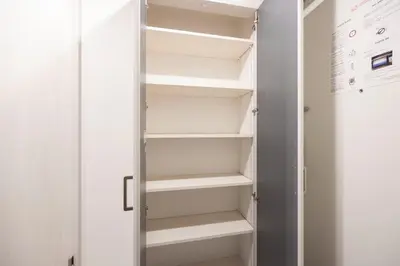 a walk in closet with white shelves at Arucia\u4e09\u8ed2\u8336\u5c4b in Tokyo