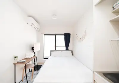 a small bedroom with a bed and a desk at テルヌファビュル亀戸 - Tokyo Urban APT in a Japanese Local Shopping Street, with Direct Access to Shinjuku & Akihabara in Tokyo