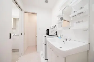 a white bathroom with a sink and a mirror at テルヌファビュル亀戸 - Tokyo Urban APT in a Japanese Local Shopping Street, with Direct Access to Shinjuku & Akihabara in Tokyo