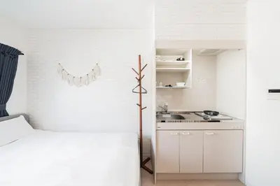 a white bedroom with a bed and a sink at テルヌファビュル亀戸 - Tokyo Urban APT in a Japanese Local Shopping Street, with Direct Access to Shinjuku & Akihabara in Tokyo