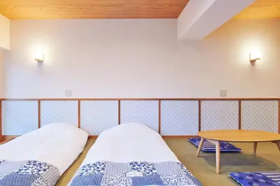 a room with two beds and a table at \u5bcc\u58eb\u306e\u9593 401 in Tokyo