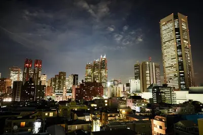 a city skyline at night with tall buildings at \u6298\u308a\u9db4\u306e\u9593 402 in Tokyo