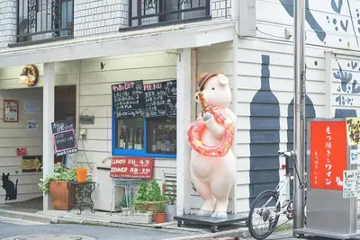a large statue of a person holding a pretzel at \u6298\u308a\u9db4\u306e\u9593 402 in Tokyo
