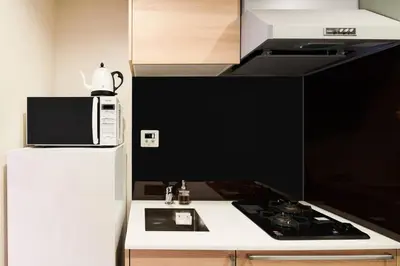 a microwave sitting on top of a refrigerator in a kitchen at \u6298\u308a\u9db4\u306e\u9593 402 in Tokyo