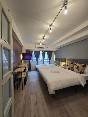 a hotel room with two beds and a table and chairs at Perfect Hot Location, Shibuya! in Tokyo