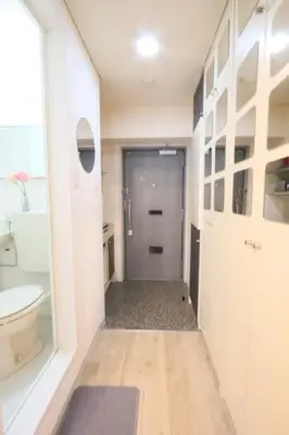 a bathroom with a hallway with a toilet and a sink at Perfect Hot Location, Shibuya! in Tokyo