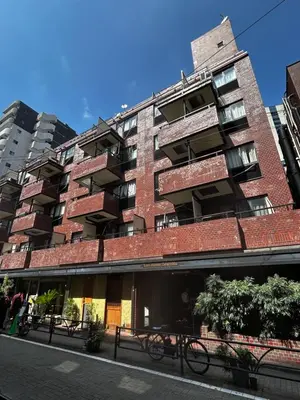 a tall red brick building on a city street at Perfect Hot Location, Shibuya! in Tokyo