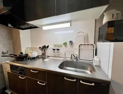 a kitchen with a sink and a white refrigerator at ペットと泊まれる Tatami & B 池上 202 2DK 40m2 in Tokyo