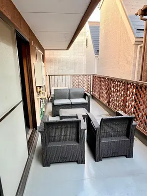 a balcony with wicker chairs and tables at ペットと泊まれる Tatami & B 池上 202 2DK 40m2 in Tokyo