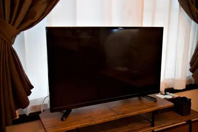a flat screen tv sitting on top of a wooden table at TOMARIE Horikiri Residential Suite in Tokyo