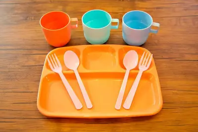 an orange tray with forks and cups on a table at TOMARIE Horikiri Residential Suite in Tokyo