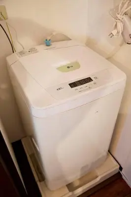a white refrigerator in a corner of a room at TOMARIE Horikiri Residential Suite in Tokyo