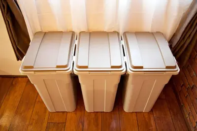 two trash cans sitting next to each other on a floor at TOMARIE Horikiri Residential Suite in Tokyo
