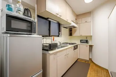 a kitchen with white cabinets and a refrigerator at \u834f\u539f\u4e2d\u5ef6\u99c5\u304b\u30893\u5206,\u5e83\u3005LDK,\u8cb8\u5207,\u54c1\u5ddd\u99c5\u307e\u306720\u5206,comfortable in Tokyo