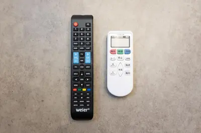 a remote control and a cell phone on a table at Link COURT\u897f\u65b0\u5bbf in Tokyo