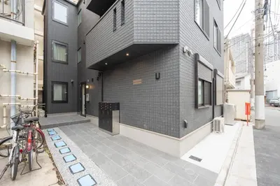 a building on a street with a bike parked on the sidewalk at Link COURT\u897f\u65b0\u5bbf in Tokyo