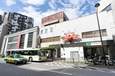 a bus is parked in front of a building at Link COURT\u897f\u65b0\u5bbf in Tokyo
