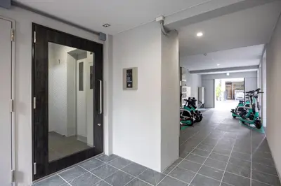 a hallway with a mirror and motorcycles in a gym at \u30a2\u30a4\u30ea\u30b9\u62bc\u4e0a in Tokyo