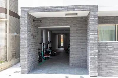 a brick building with bikes parked in a hallway at \u30a2\u30a4\u30ea\u30b9\u62bc\u4e0a in Tokyo
