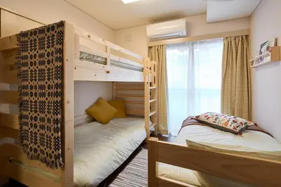 a bedroom with two bunk beds and a window at Liberty house 7ppl in Tokyo