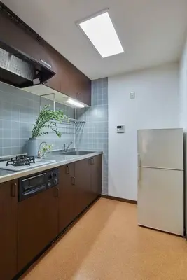 a kitchen with a white refrigerator and a sink at Liberty house 7ppl in Tokyo