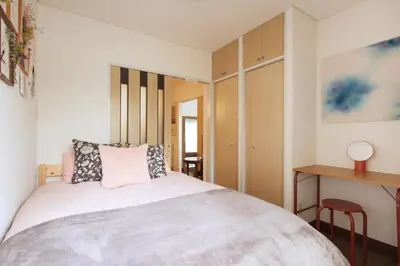 a small bedroom with a bed and a desk at Liberty house 7ppl in Tokyo