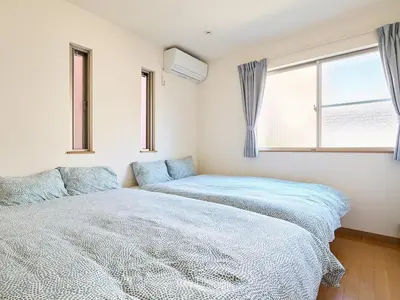 a bedroom with two beds and a window at KandoStay TOKYO\u30c6\u30e9\u30b9 in Tokyo