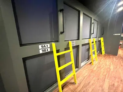 a row of doors in a room with yellow ladders at \u65b0\u5bbf\u30cb\u30c3\u30ab\u30db\u30c6\u30eb in Tokyo