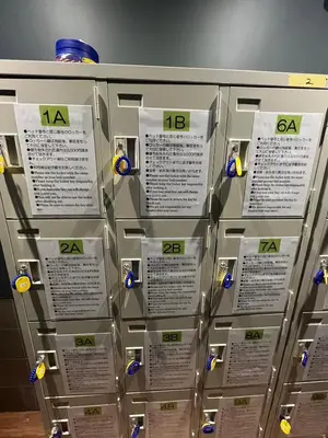 a stack of metal machines with labels on them at \u65b0\u5bbf\u30cb\u30c3\u30ab\u30db\u30c6\u30eb in Tokyo