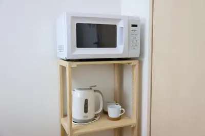 a microwave and a coffee maker on a shelf at \u30cf\u30a4\u30af\u30ec\u30b9\u30c8\u4e2d\u91ce201 in Tokyo