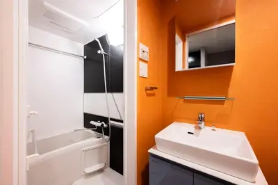 a bathroom with a sink and a tub and a mirror at lighthouse otsuka in Tokyo