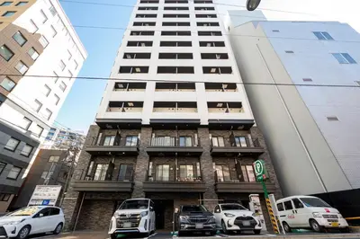 a tall building with cars parked in front of it at lighthouse otsuka in Tokyo