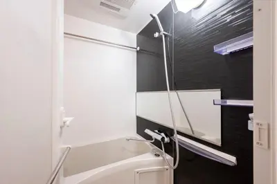 a bathroom with a shower with a glass door at lighthouse otsuka in Tokyo