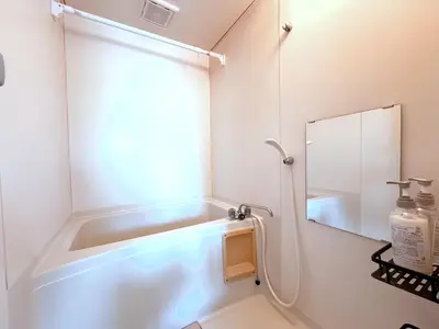 a bathroom with a bath tub and a mirror at Kosuge Sta 6min walk Ueno Sta 10min Switch in Tokyo