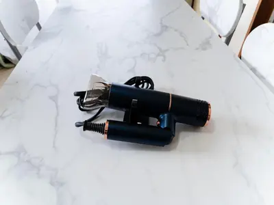 a black flashlight sitting on a white table at Kosuge Sta 6min walk Ueno Sta 10min Switch in Tokyo