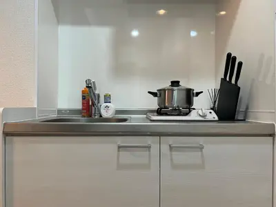 a kitchen with a sink and a pot on a stove at Ikebukuro Area 41 NishiikeApartment in Tokyo
