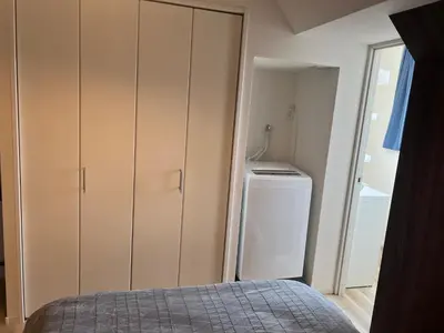 a bedroom with a closet and a washer and dryer at Ikebukuro Area 41 NishiikeApartment in Tokyo